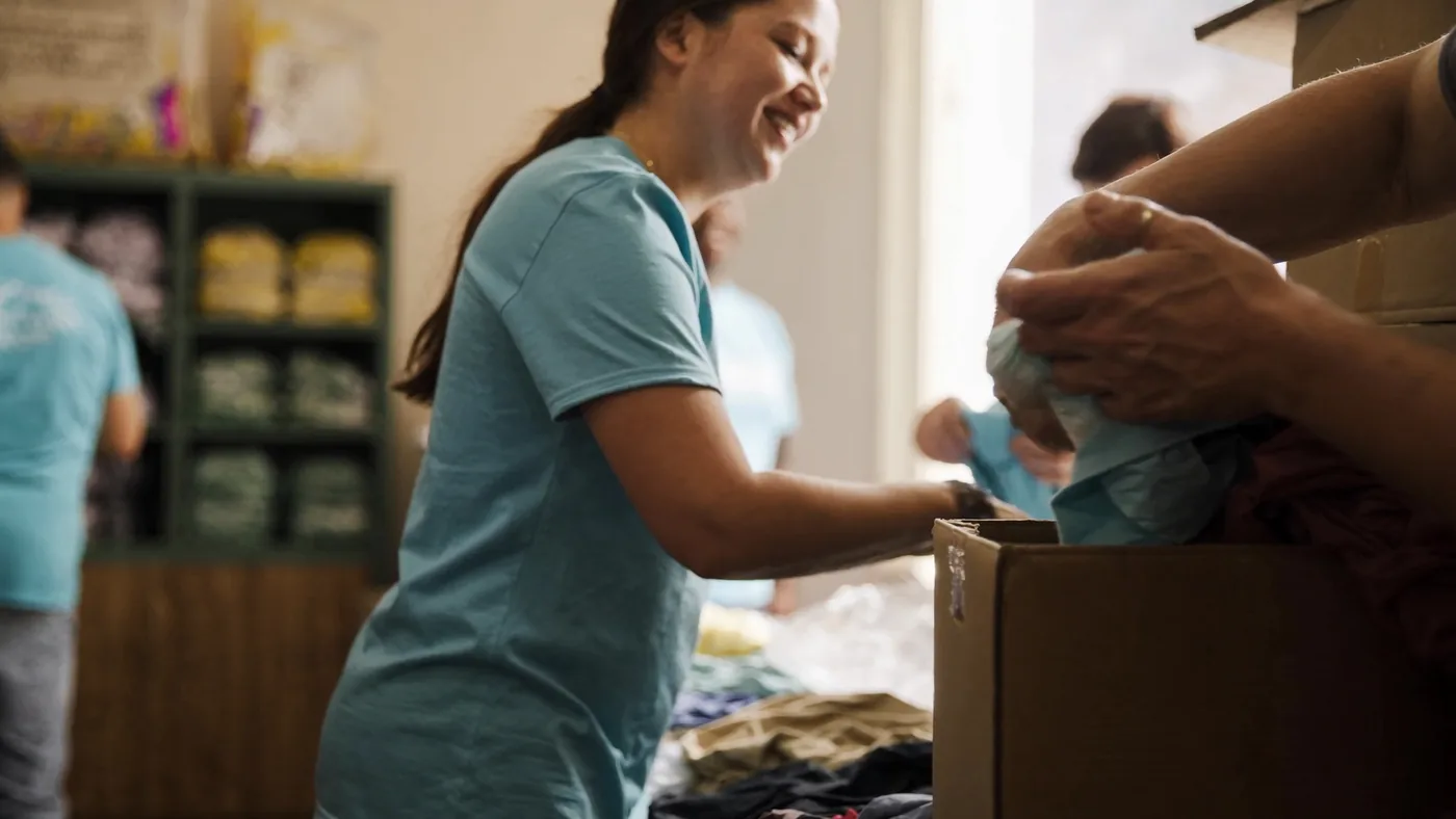 Volunteers sorting and packing donated clothing and supplies